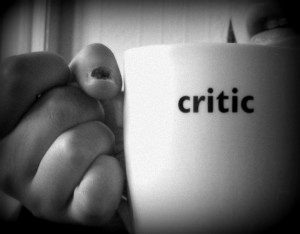 Everyone's a Critic: photo credit - Lis Ferla black and white image of hand holding cup with word critic on it
