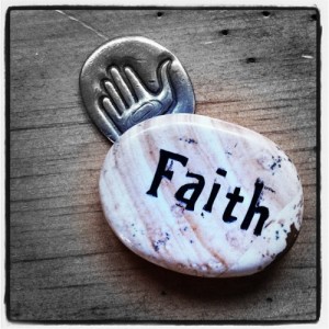 Companions: photo credit - Sandi Amorim touchstone inscribed with the word faith next to healing hand coin