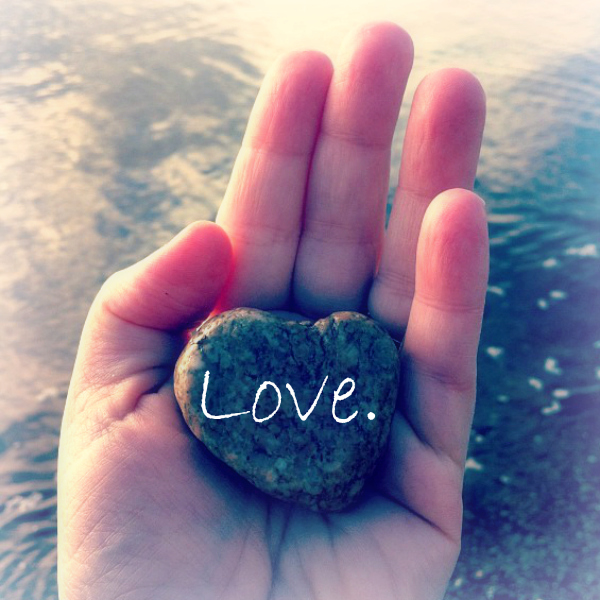 Love Hand holding heart shaped rock